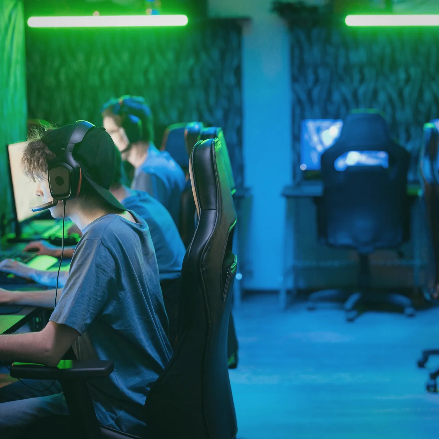 Members gathered around a large screen during a match at a monthly meetup